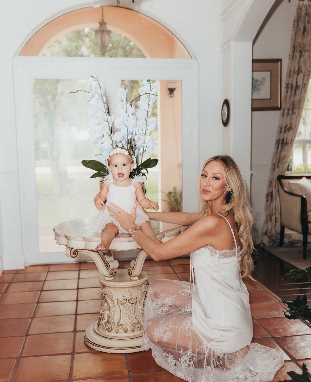 Mother and toddler in an arched doorway at Maison Sarti — lifestyle and family session on location