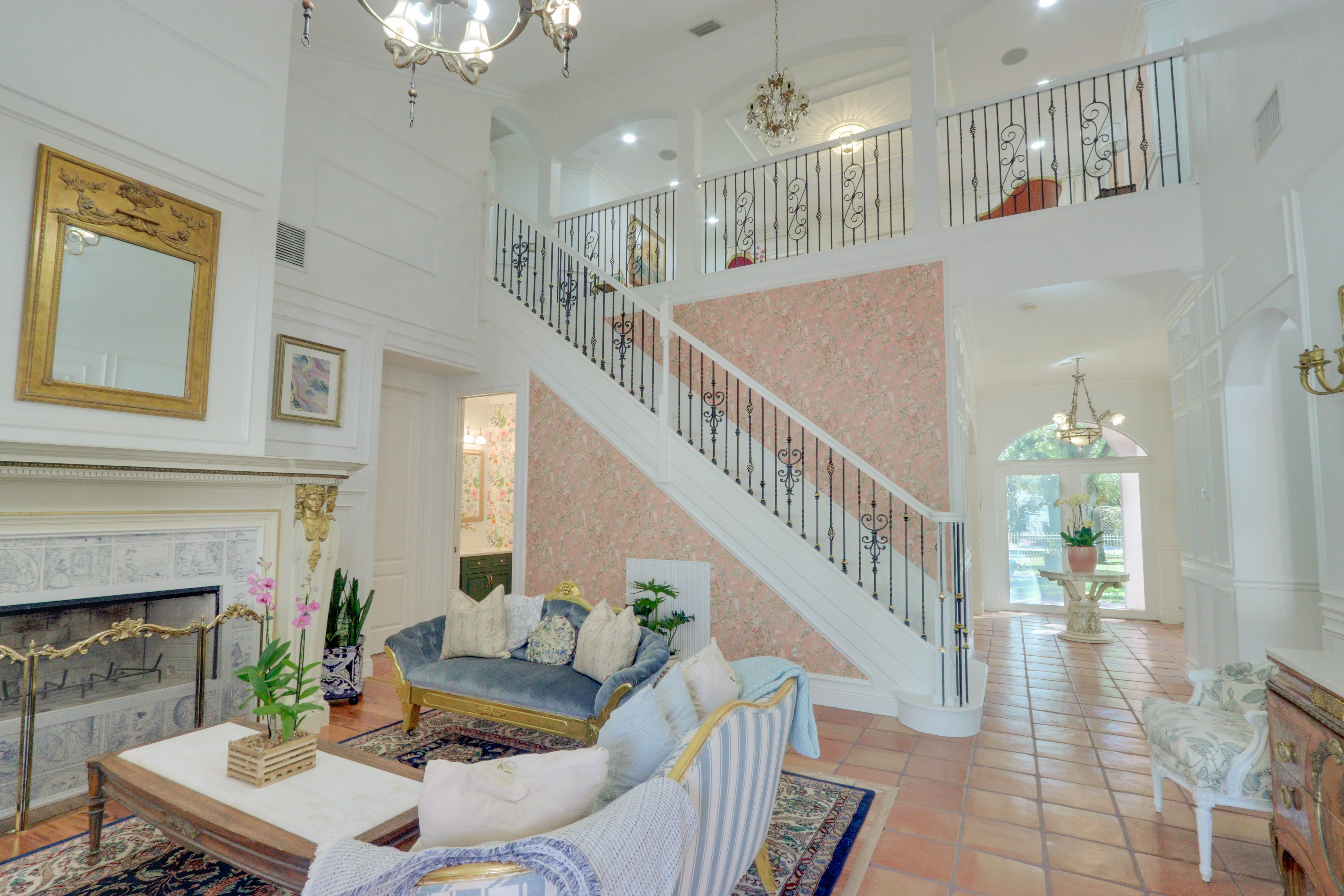 Grand Salon alternate view with staircase and living seating at Maison Sarti