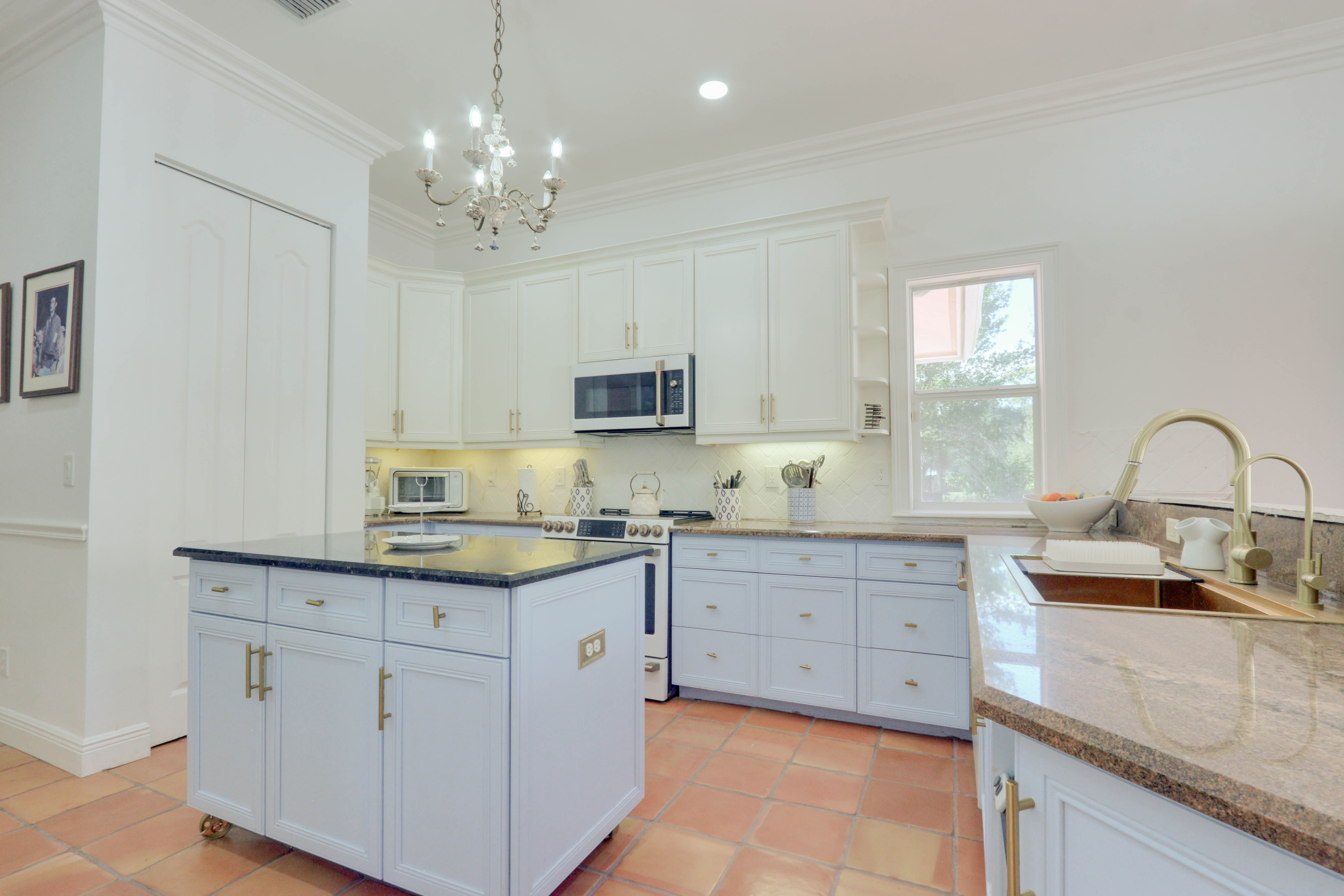 Culinary kitchen island at Maison Sarti with pale blue cabinets