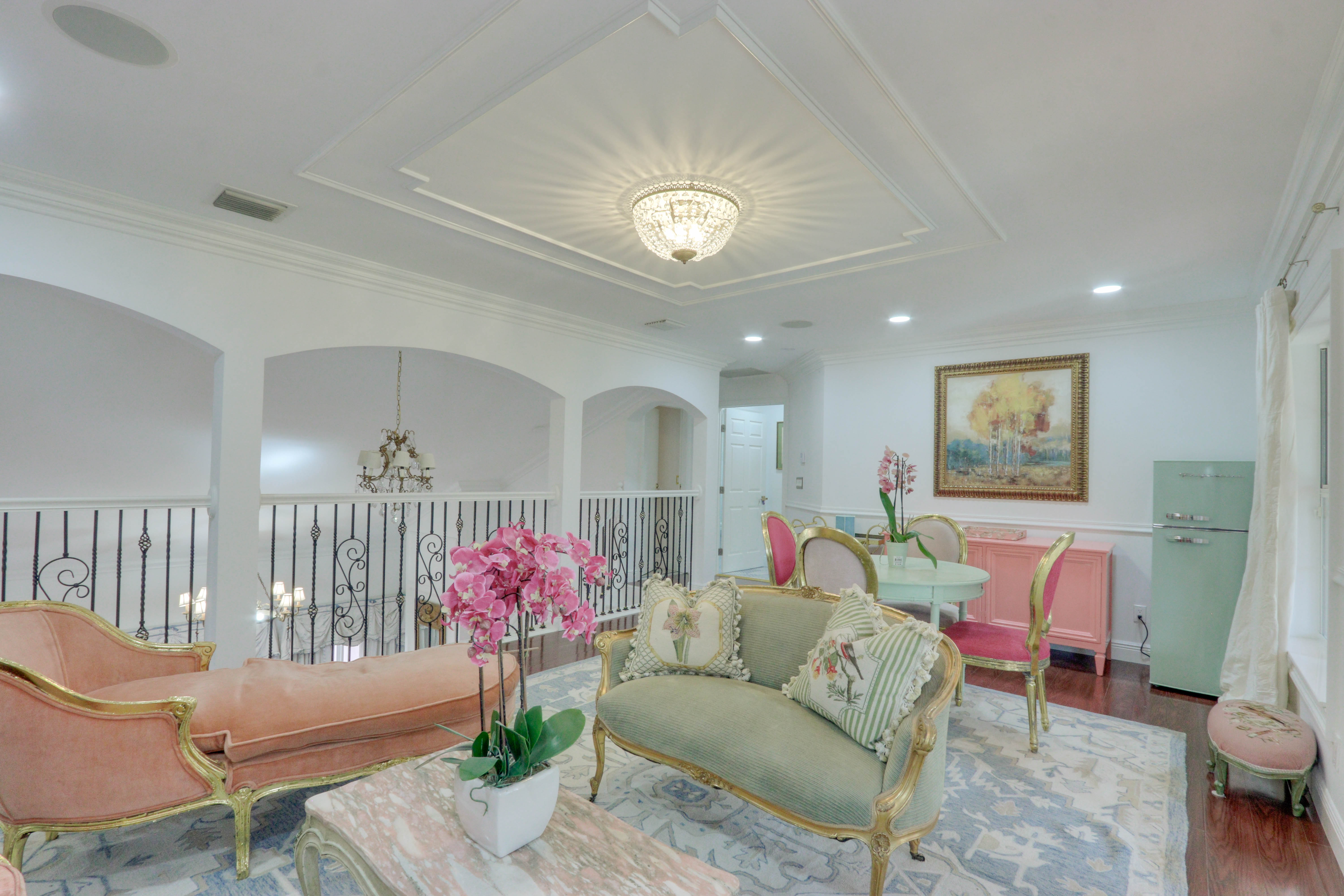 Upstairs peach and sage lounge at Maison Sarti — soft romantic interim for the Azure Suite